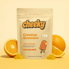 Cheeky Creatine Gummies Orange Creamsicle flavor pouch surrounded by orange slices on yellow background.